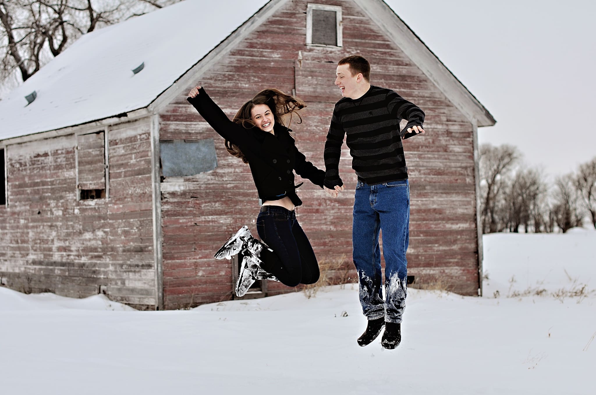 couple jumping in the snow