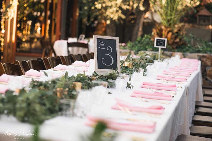 bohemian wedding ceremony, eucalyptus garland, pink and gold tablescapes, artisan events palm springs, chalkboard table numbers