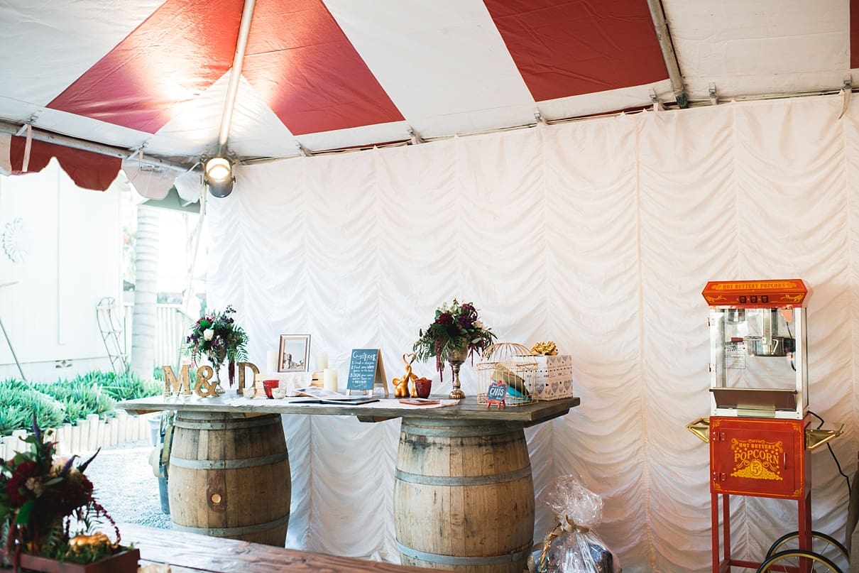 backyard vintage carnival wedding, weddings under the big top, whiskey barrels at weddings, popcorn bar at weddings