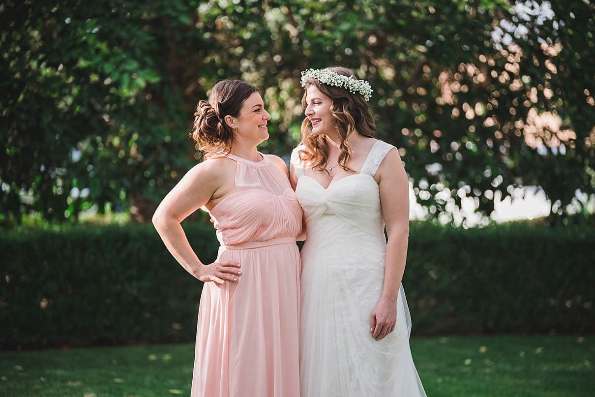 bride with sister, pink bridesmaid dress