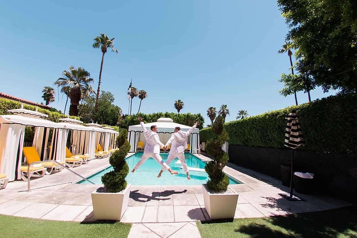 two grooms jumping into the pool