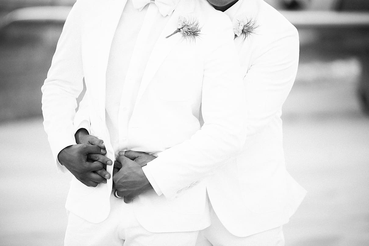gay wedding pose, two grooms white suits
