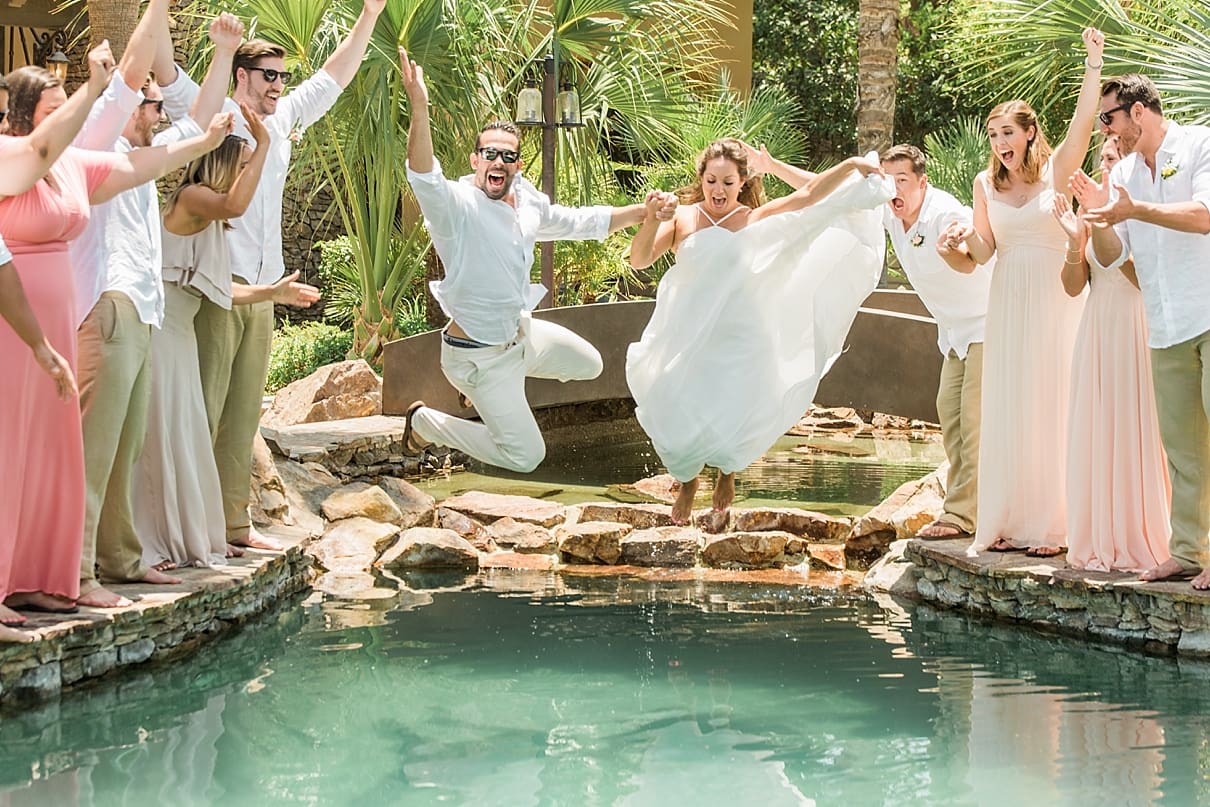 crazy bride and groom portraits, bride and groom jumping in the pool