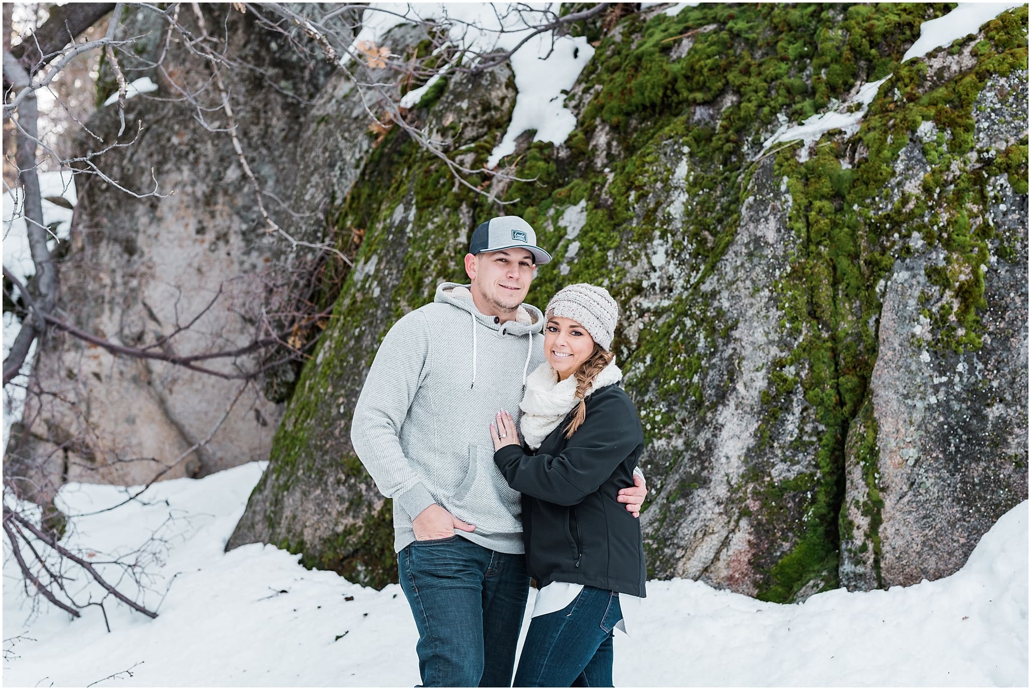 couple in front of snow and mossy rock