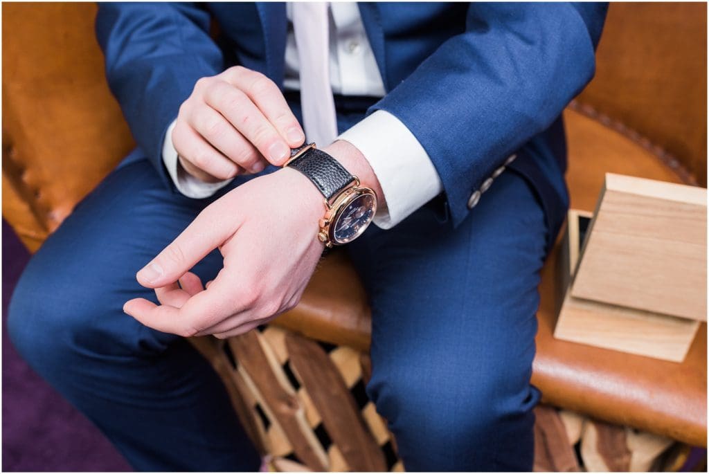 groom putting on watch gift from fiancé