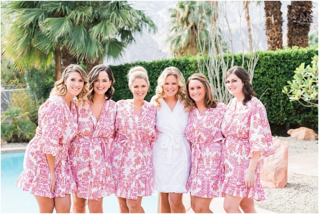 bride with bridesmaids in pink robes