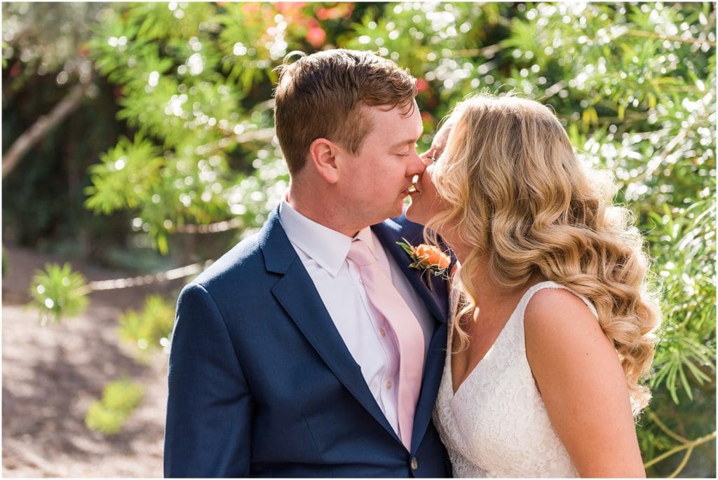 bride and groom kissing in a lemon grove