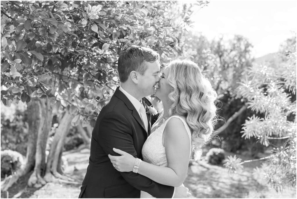black and white bride and groom kissing portrait
