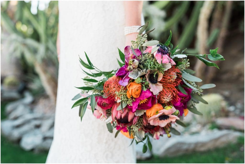 bride holding on to a brightly colored bouquet
