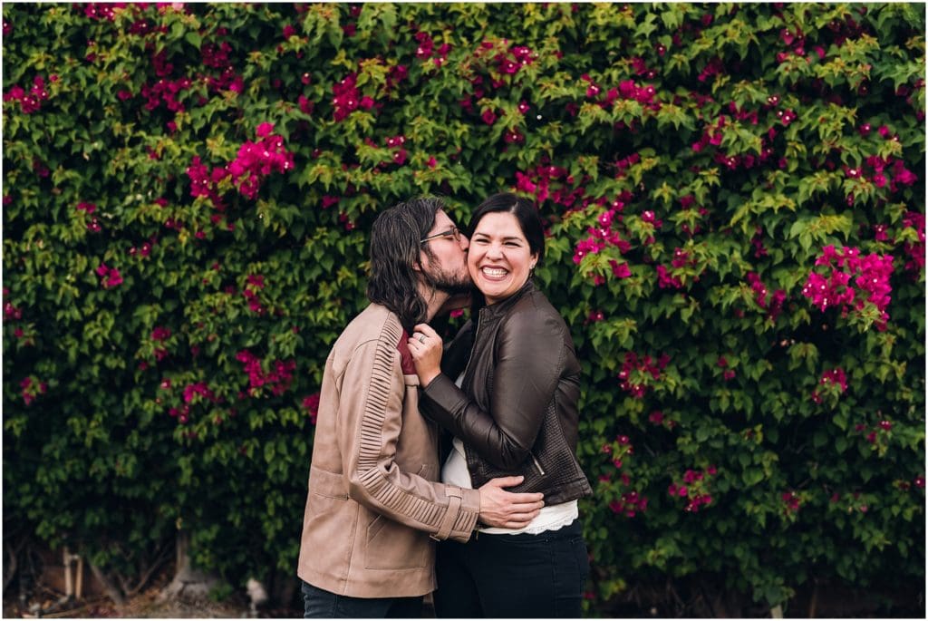 husband kissing wife on the cheek