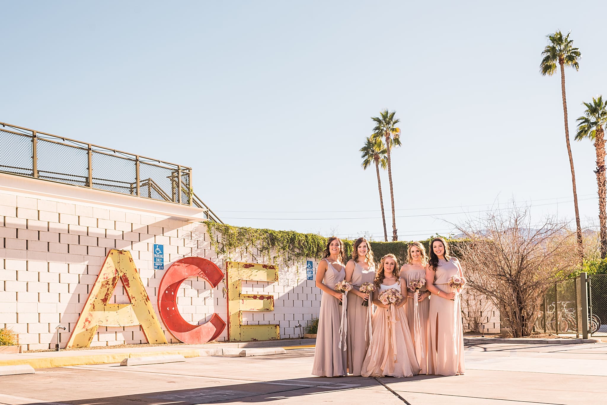 bridal party in front of the ace hotel sign in palm springs