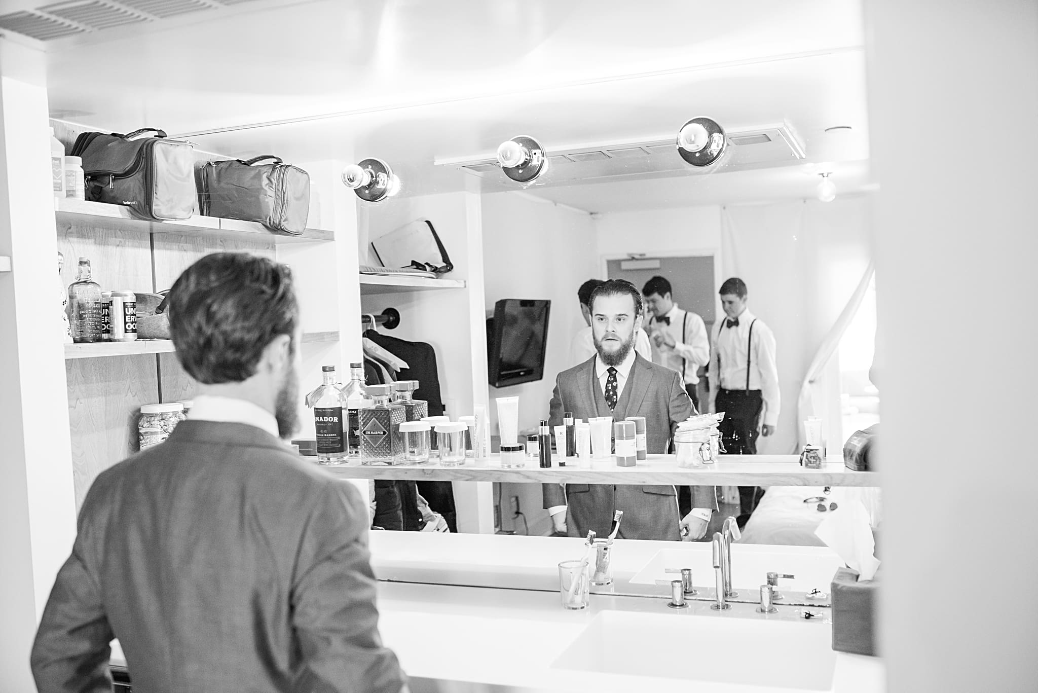 groom taking a look in the mirror