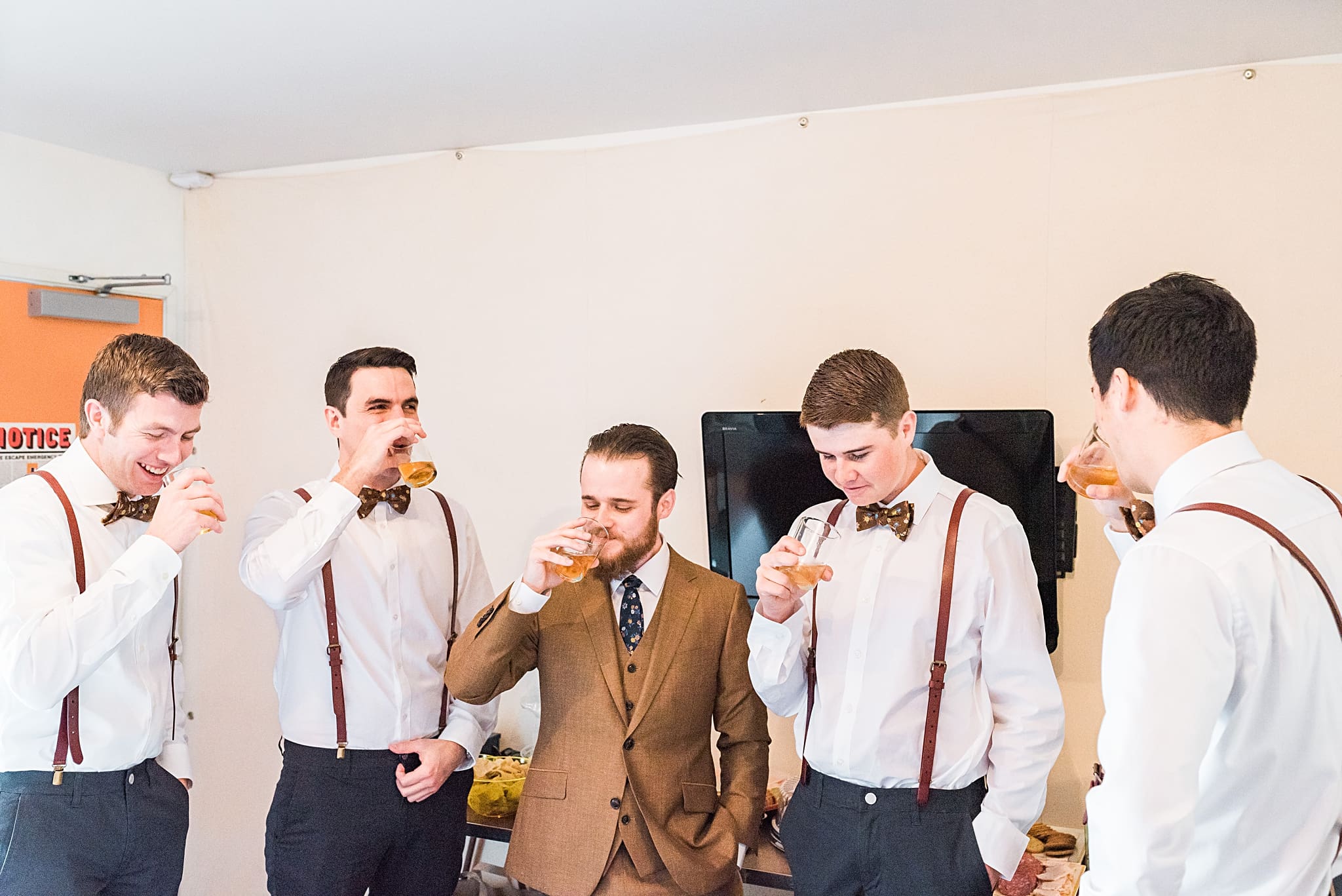 groom with groomsmen taking bourbon shots