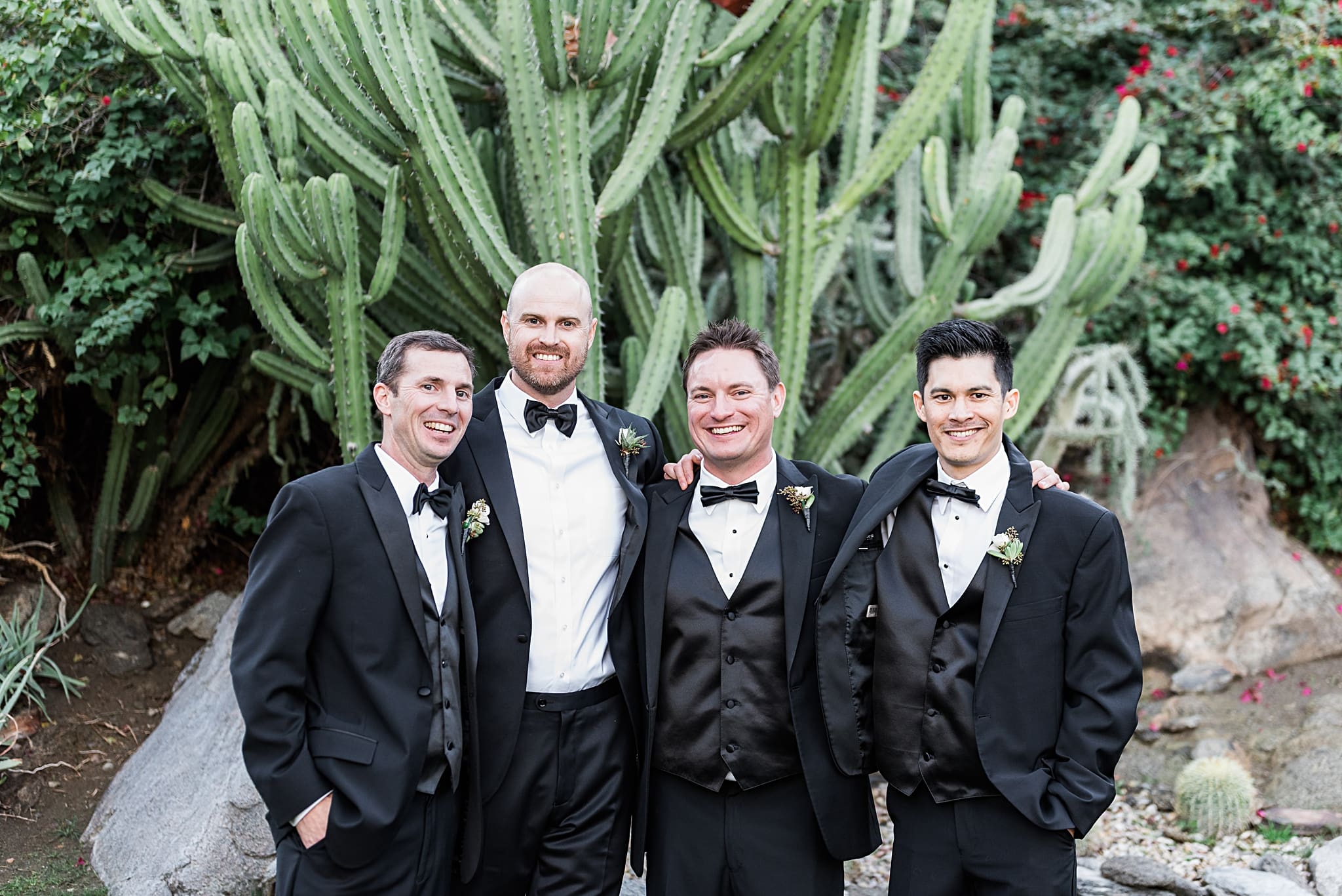 groom with groomsmen in front of a cactus