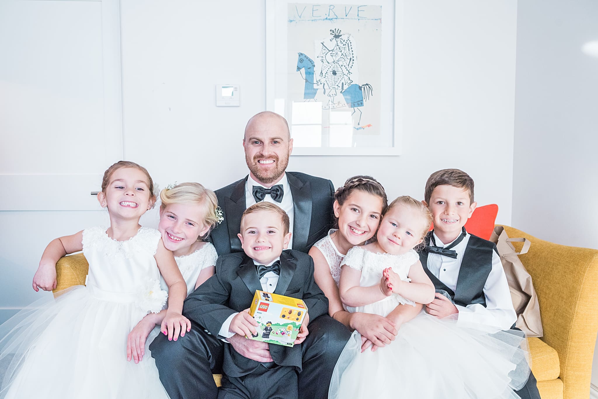 groom with flower girls and ring bearers