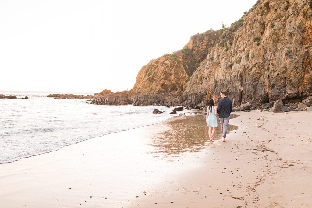 couple walking on crescent bay beach