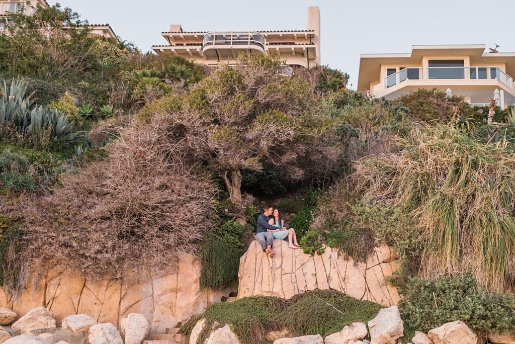 couple hanging out in a cave at laguna beach