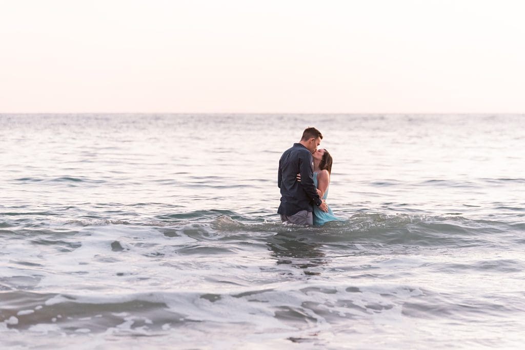 couple kissing in the pacific ocean