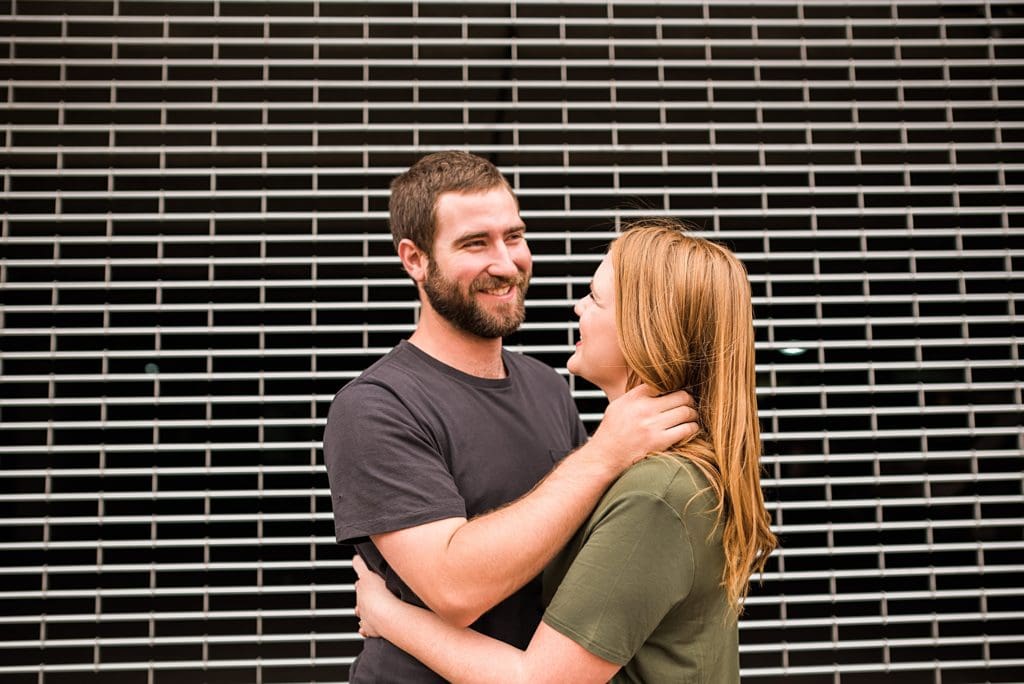 couple laughing with each other in front of parking garage