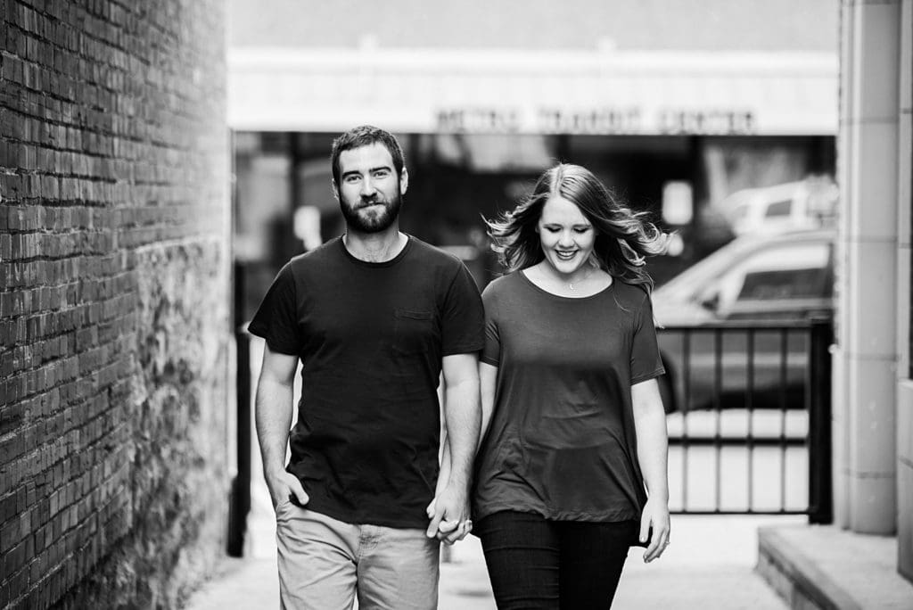 couple walking together down an alleyway