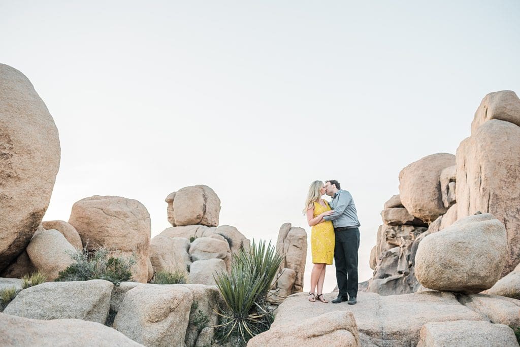 couple kissing on the jumbo rocks at joshua tree