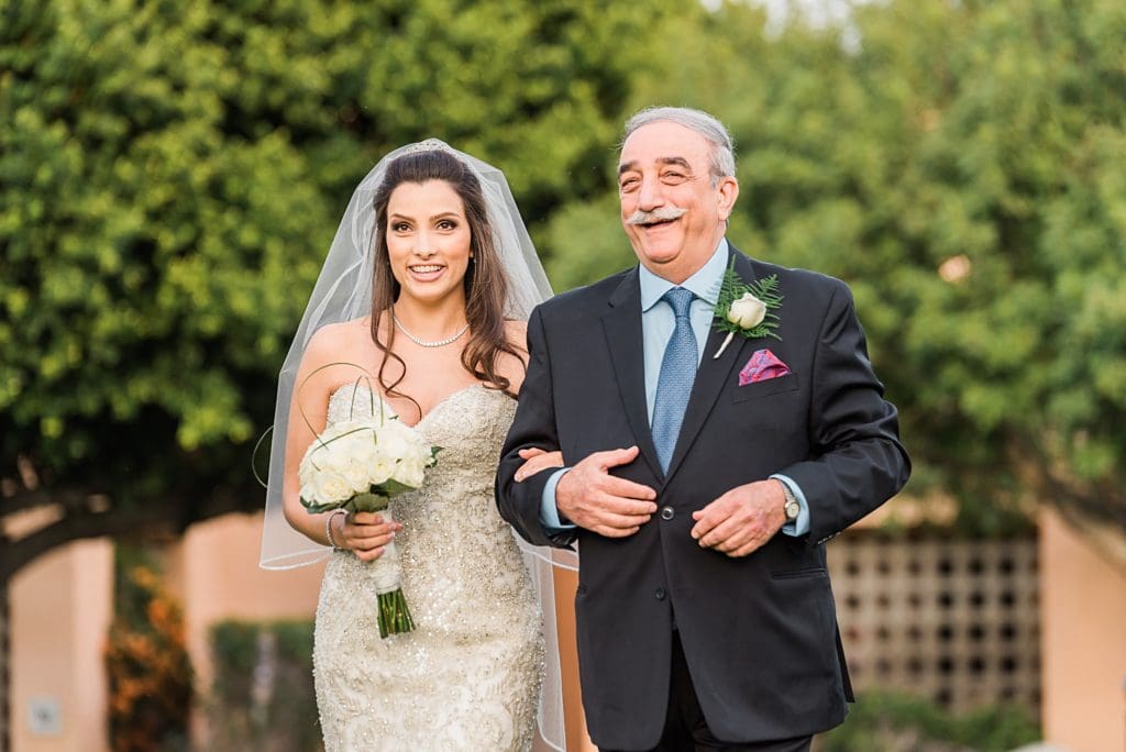 excited father escorting daughter down the aisle