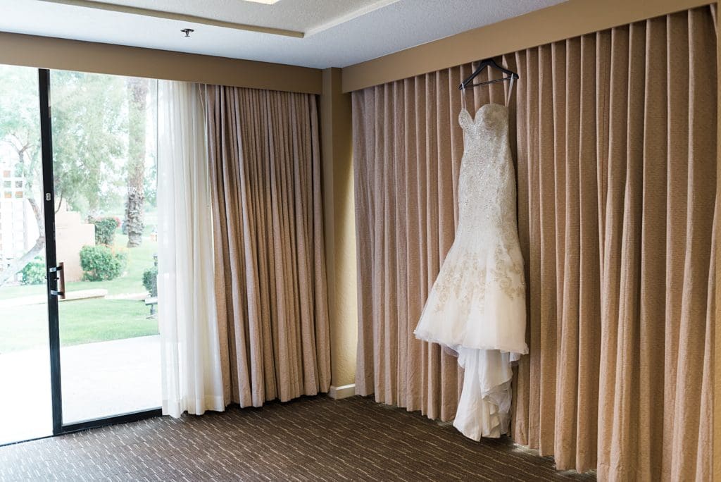 bridal gown hanging up in the window