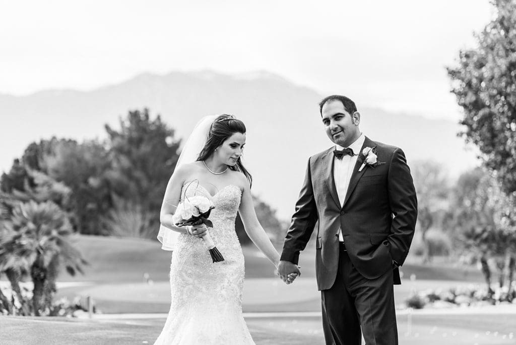 bride and groom walking together on the golf course