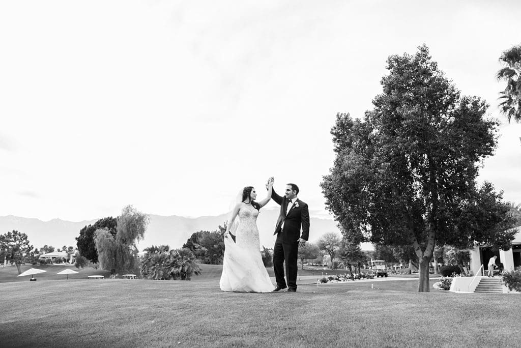 bride and groom dancing on golf course