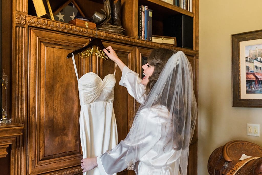 bride taking dress off the hanger