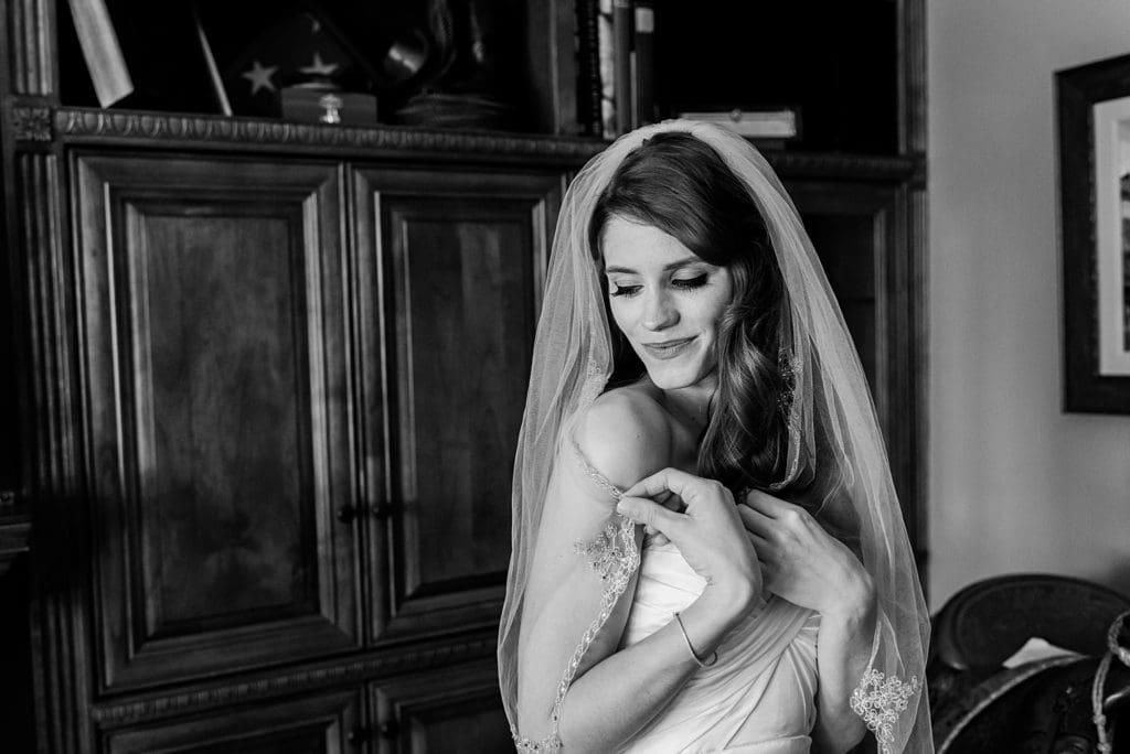 bride wrapping herself in veil