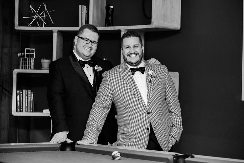 grooms in front of pool table