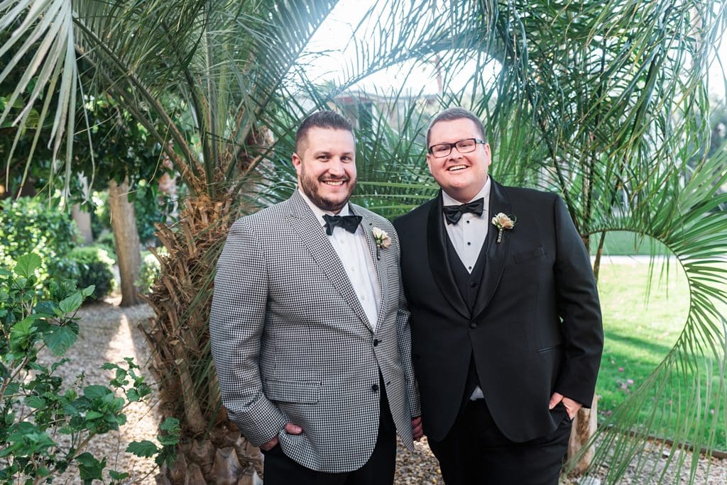 grooms in front of palm trees