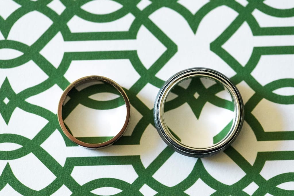 grooms rings with wedding invitations