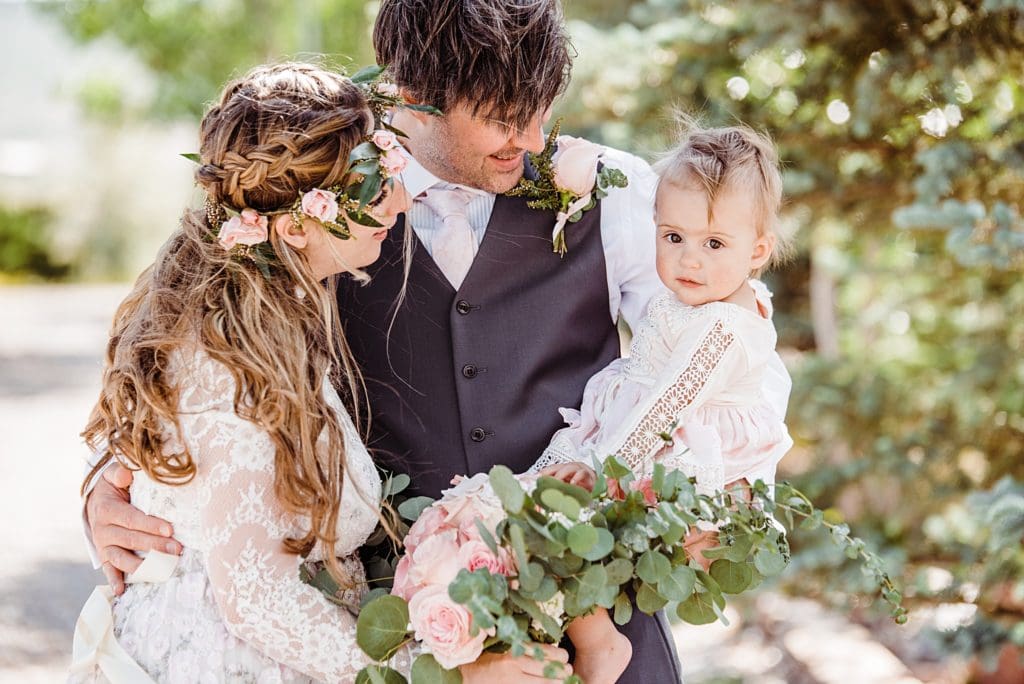 bohemian wedding bride and groom with baby
