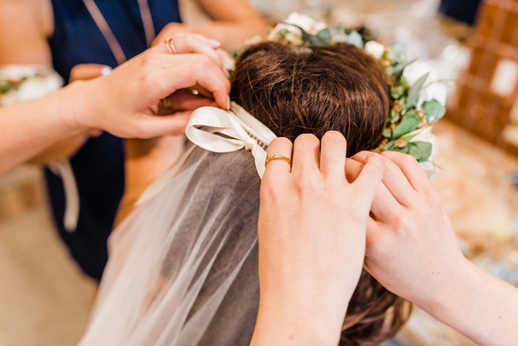 putting brides veil in