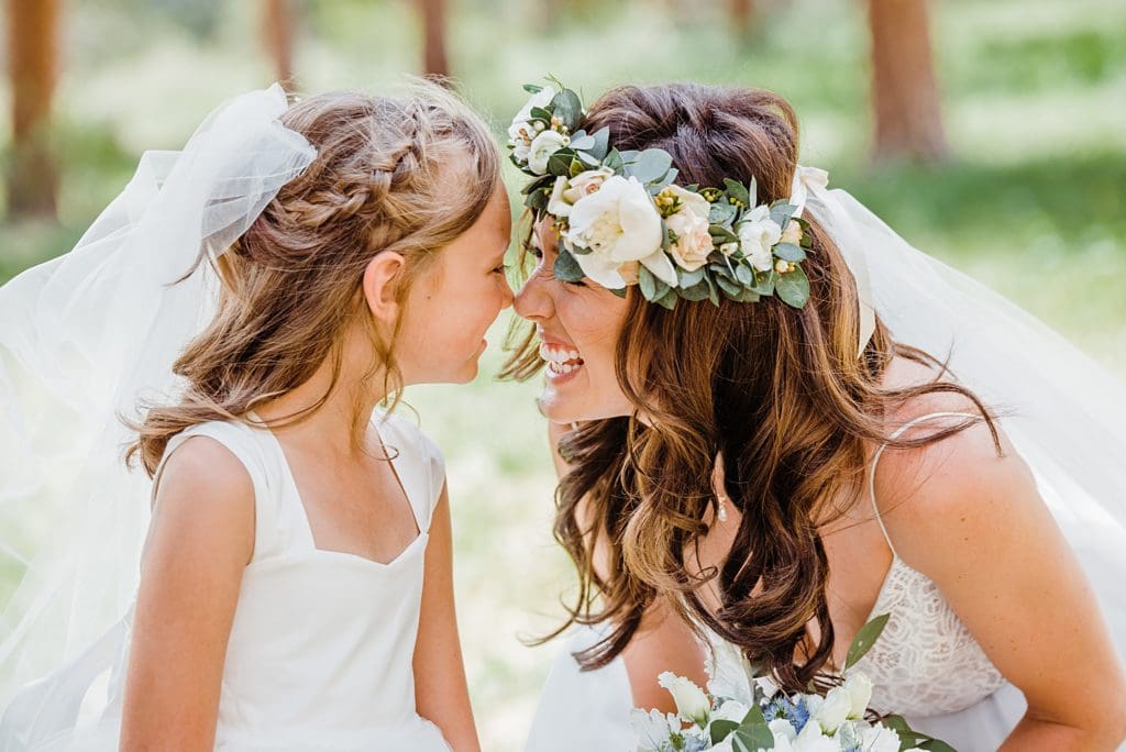 bride and flower girl nuzzling noses
