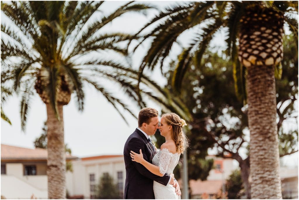 bride and grooms portraits with large palm trees