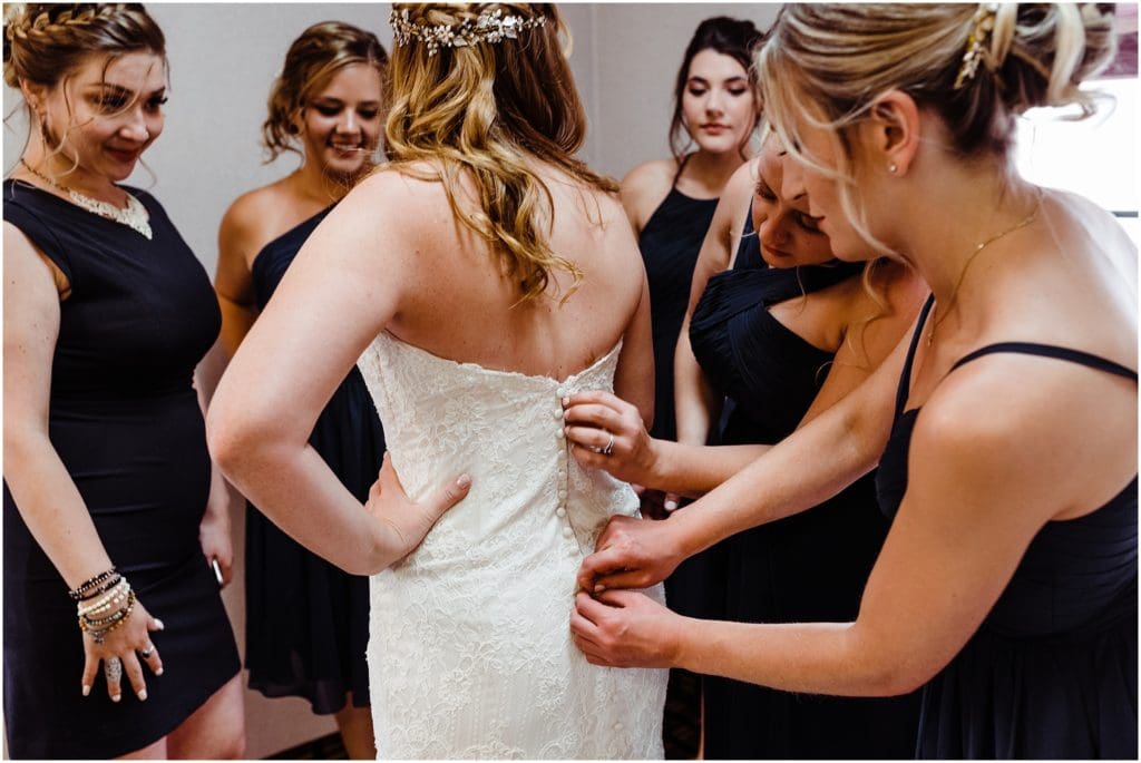 bride getting dressed in conference room