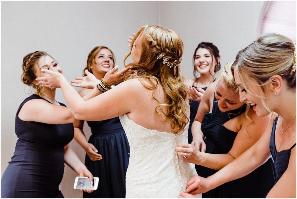 bride getting dressed in conference room