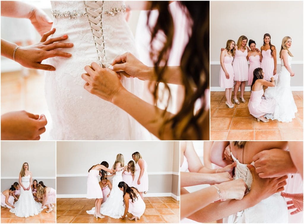 bride getting dressed with her bridesmaids