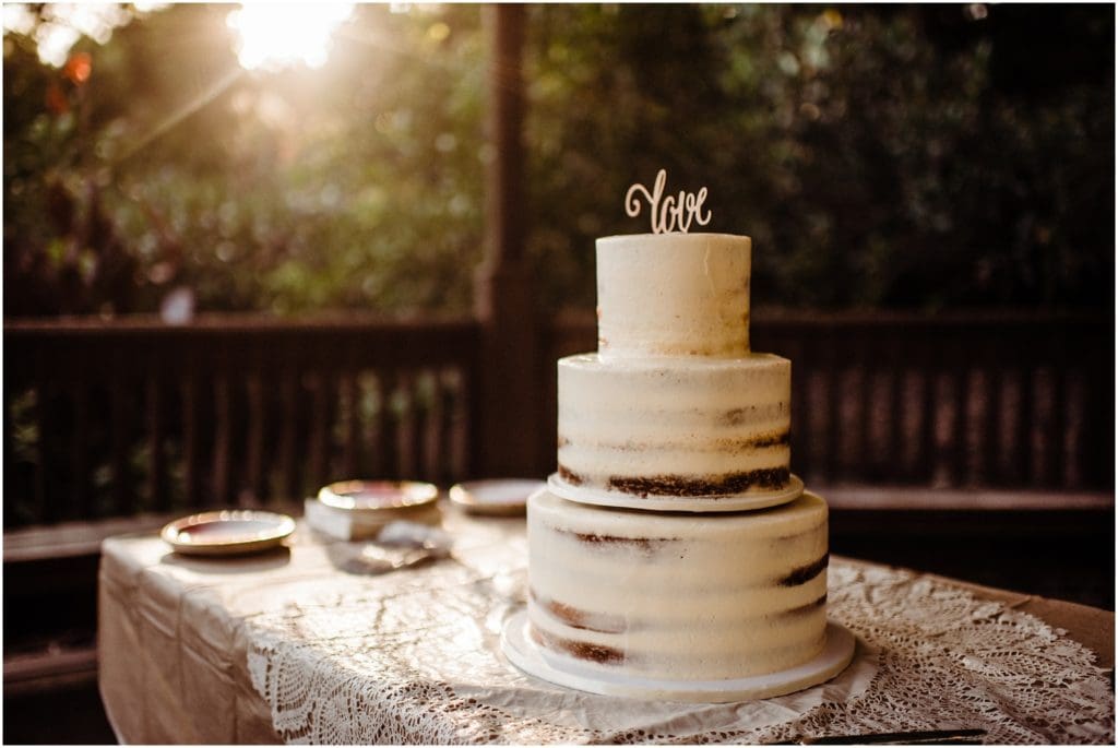 naked wedding cake with love topper