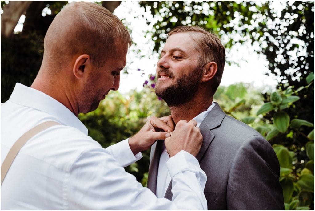 groom's brother helping him get ready