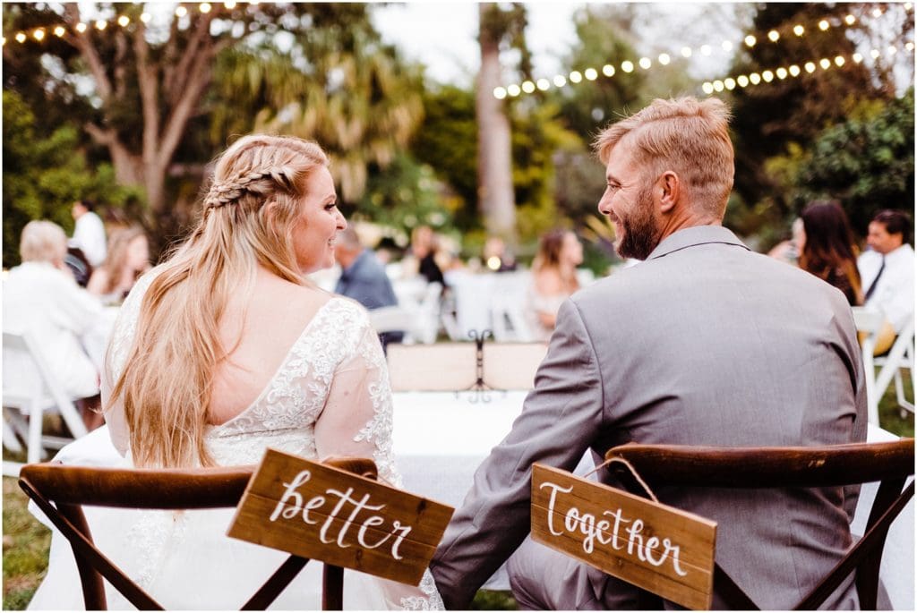 bride and groom with better together sign