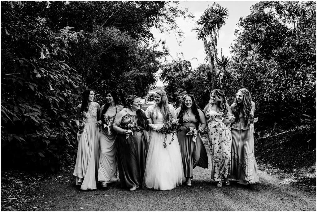 black and white bridal party portrait in a botanic garden