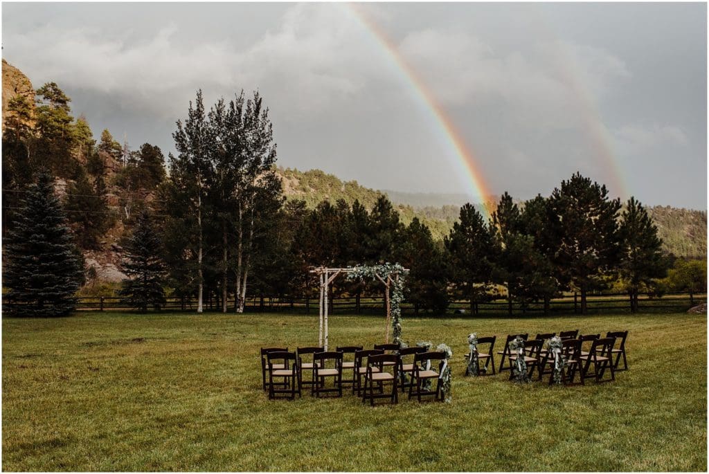 outdoor wedding ceremony with a double rainbow