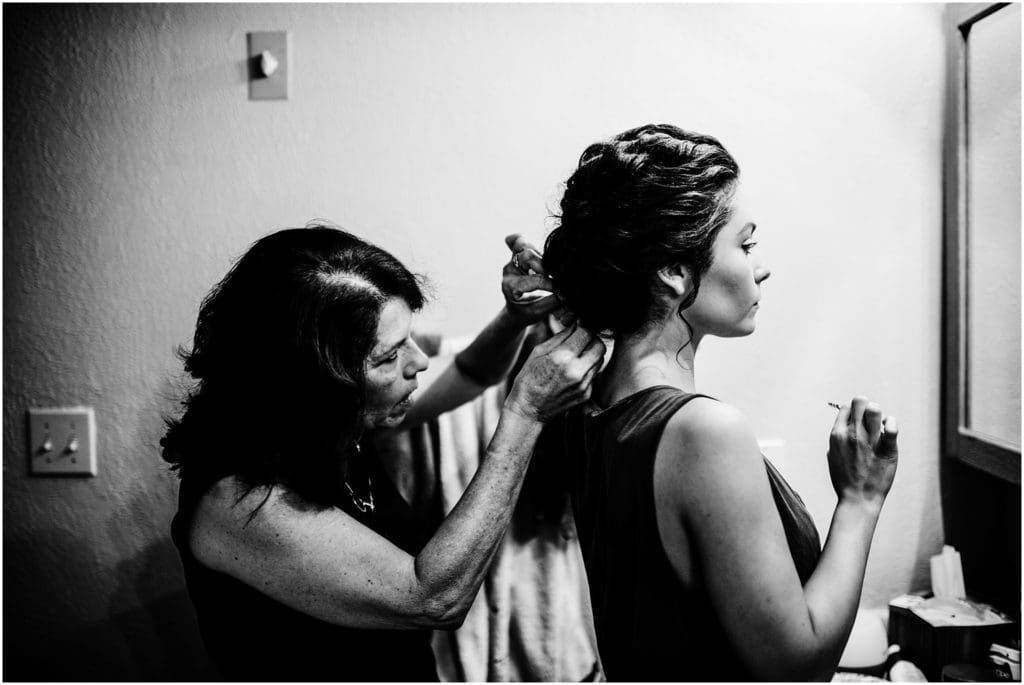 mom pinning bride's hair