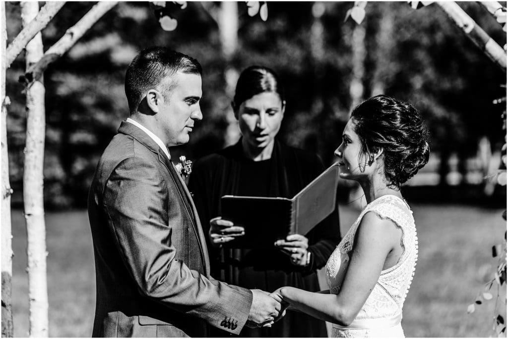 black and white photo of exchanging vows