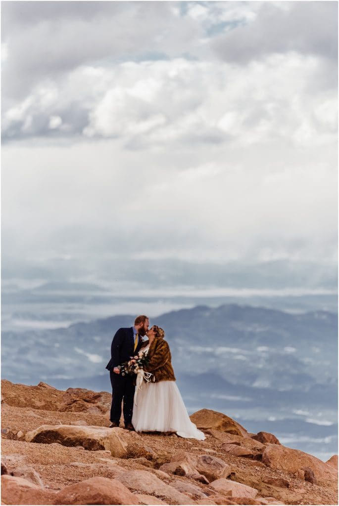 kissing on the top of a mountain