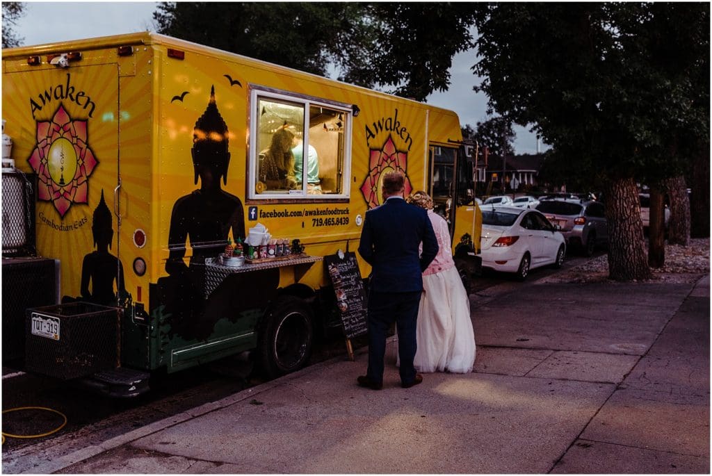 bride and groom with their food truck